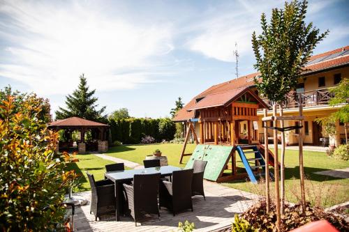 a backyard with a table and a playground at Penzion Fortune in Dunajská Streda