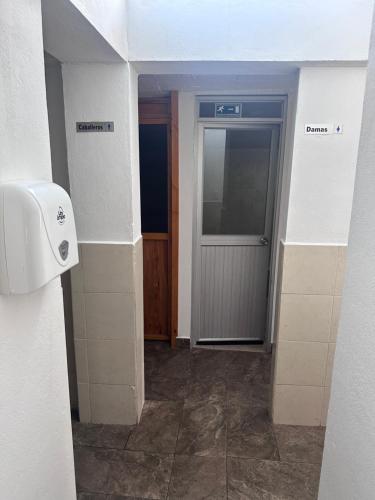 an empty hallway with a door in a building at W i M, Hostel & Camping in Chaupi