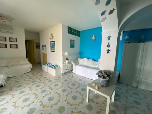 a room with a bed and a blue wall at Le terrazze in Massa Lubrense