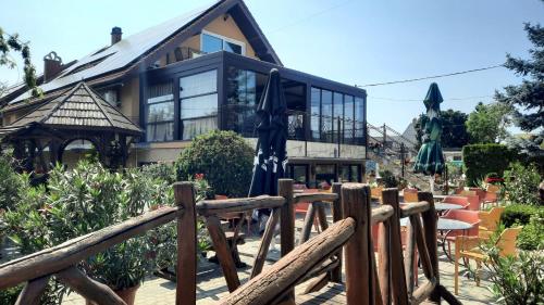 a house with a wooden fence in front of it at Sarokhaz Panzio in Vecsés