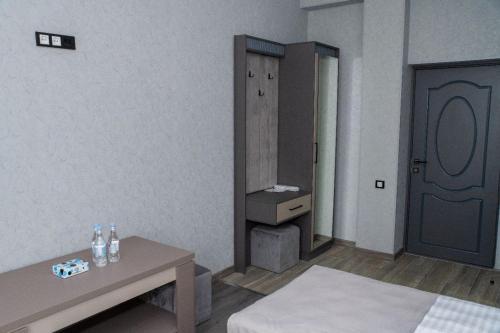 a living room with a table and a mirror at Max Hotel, Tatev 