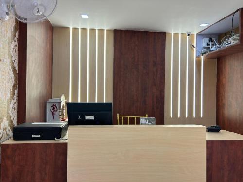 a lobby with a reception desk with avertisement at Hotel Elite rooms & Banquet in Prayagraj