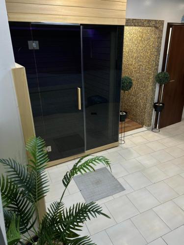 a glass door in a room with a tile floor at Art Hotel in Slavonski Brod