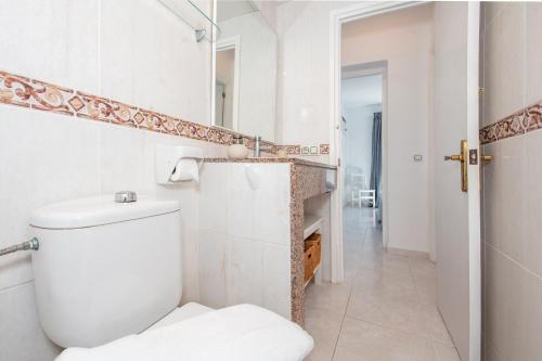 a bathroom with a toilet and a walk in shower at Apartamento Biniforcat 28 in Cala en Forcat