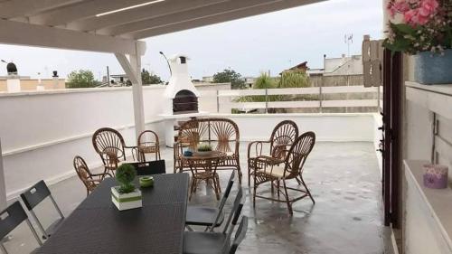 a patio with a table and chairs on a roof at Casa vacanza dai Nonni Ntoni in Acquarica del Capo