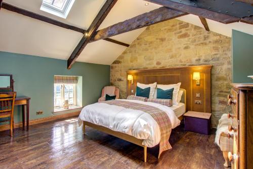 En eller flere senge i et værelse på Coach Cottage Northumberland