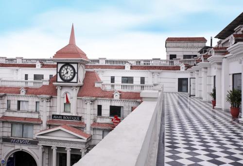a clock tower on a building with a checkered floor at Avari Boutique Gujranwala in Fattu Mand