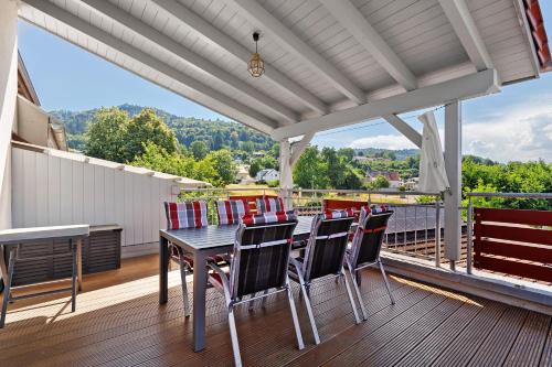 a table and chairs on the deck of a house at Reiselust in Stockach