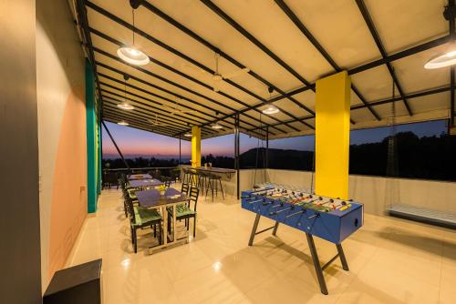 a group of tables and chairs on a balcony at The Hosteller Gokarna in Gokarna