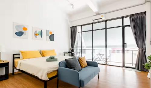 a bedroom with a bed and a blue couch at Homemade Ice cream house in local village in Bangkok
