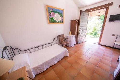 a bedroom with a bed and a table and a door at Locanda dell'Angelo in Palazzo