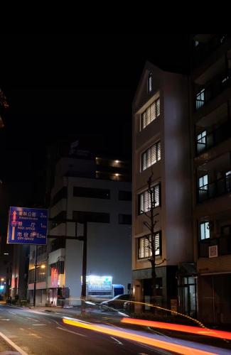 a city street at night with a building and cars at Jasmin錦町4F 高松駅近 モダン空間 in Takamatsu
