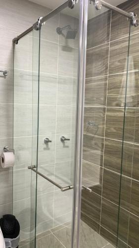 a shower with a glass door in a bathroom at el tambo de jhally 2 in Paipa