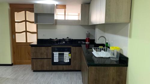 a kitchen with a stove and a counter top at el tambo de jhally 2 in Paipa