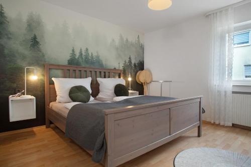 a bedroom with a bed with a painting on the wall at Geräumige schöne Ferienwohnung in Weingarten