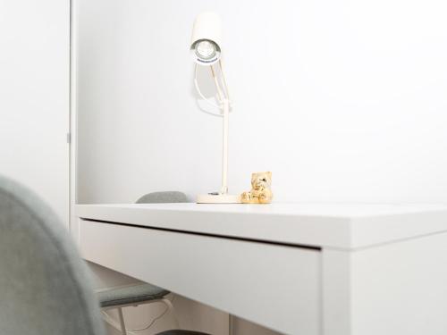 a white desk with a lamp on top of it at Lottes Hus in Lübeck