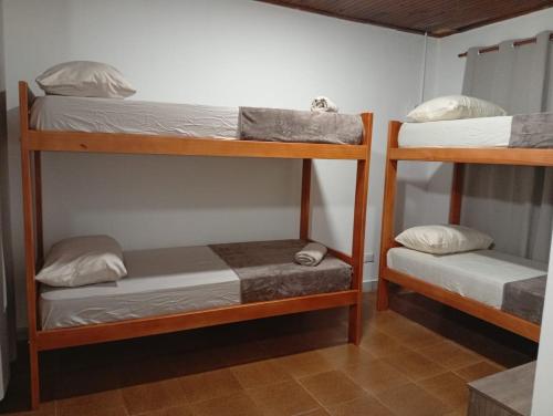 two bunk beds in a room with at Caprichos de la Selva Puerto Iguazú in Puerto Iguazú
