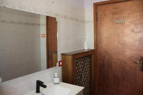 a bathroom with a sink and a mirror at Bridge To Venice in Venice