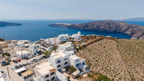 an aerial view of a town with white buildings and the ocean at Villa Happening in Imerovigli