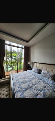 a bedroom with a large bed and a large window at sea vieww in Jakarta