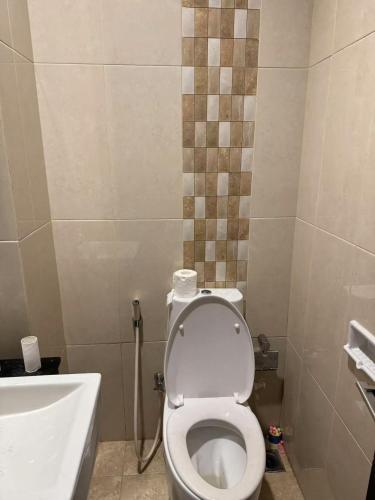 a bathroom with a white toilet and a sink at sea vieww in Jakarta