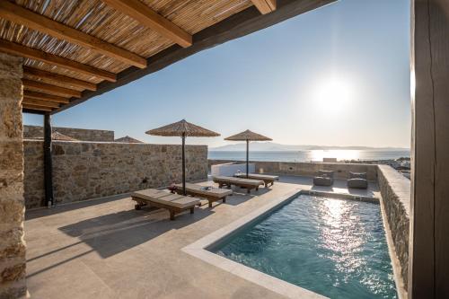 a villa with a swimming pool and a patio at Lithia Exclusive Villas & Suites in Plaka
