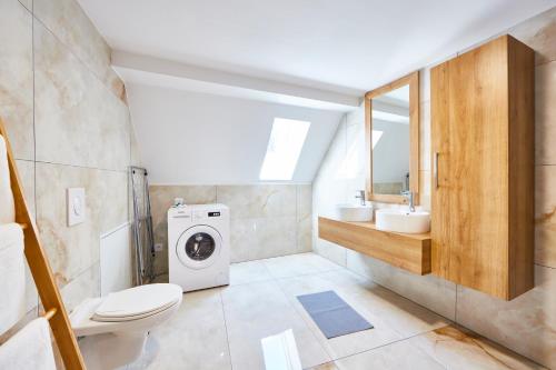 a bathroom with a washer and dryer in it at TH 202 Charmant duplex F4 au 2ème étage - 7 personnes in Thann