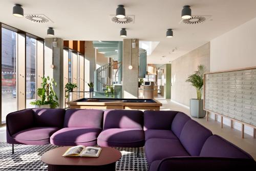 a living room with a purple couch and a pool table at For Students Only - Student Castle in Brighton in Brighton & Hove