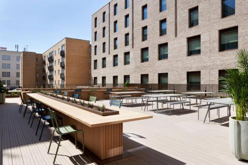 a patio with tables and chairs in front of a building at For Students Only - Student Castle in Brighton in Brighton & Hove