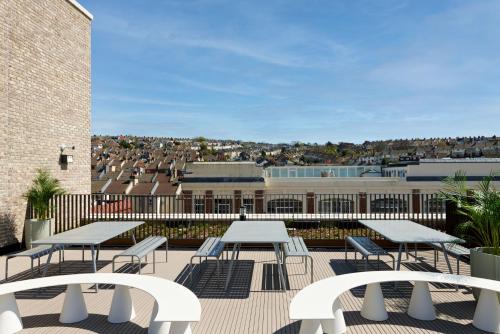 a patio with tables and chairs and a building at For Students Only - Student Castle in Brighton in Brighton & Hove
