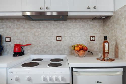 a kitchen with a white stove and a bowl of fruit at Nicolas House 1 in Rakhídhion