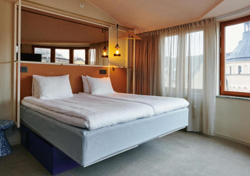 a large bed in a room with a large window at Scandic Go, Upplandsgatan 4 in Stockholm