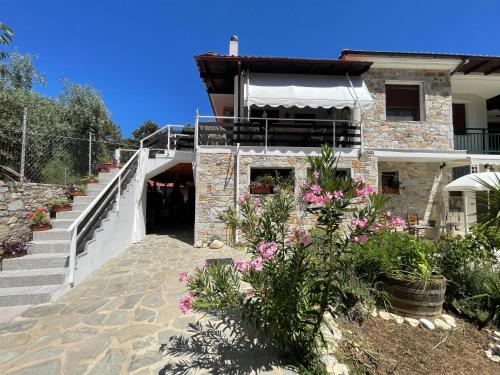 a building with stairs and flowers in front of it at Miro & Lana vacation home in Kinira