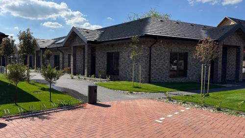 a house with a brick driveway in front of it at Penzión Pri Mlyne in Nitra