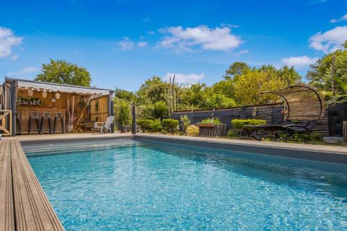 une piscine dans une cour avec une maison dans l'établissement Le Grand T2 d'Andernos, à Andernos-les-Bains