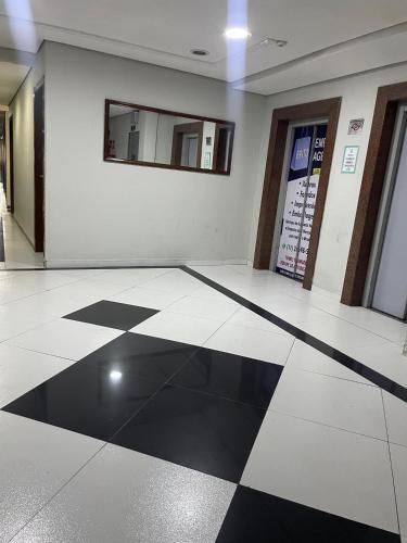 a lobby with a black and white checkered floor at Hotel Family São Paulo - No Shopping FAMILY - No Brás in Sao Paulo