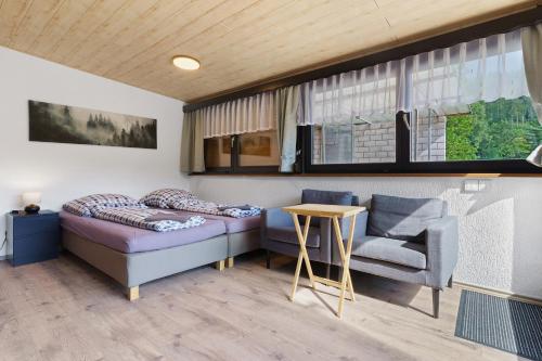 a living room with a couch and a chair at Ferienwohnung am Braunberg in Oppenau