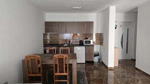 a kitchen with a table and chairs and a microwave at MALM Travnik in Travnik