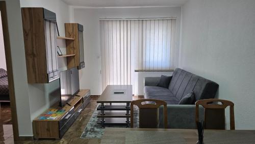 a living room with a couch and a table at MALM Travnik in Travnik