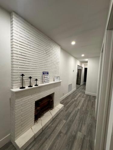 a living room with a white brick fireplace at Santuaria Hollywood in Hollywood