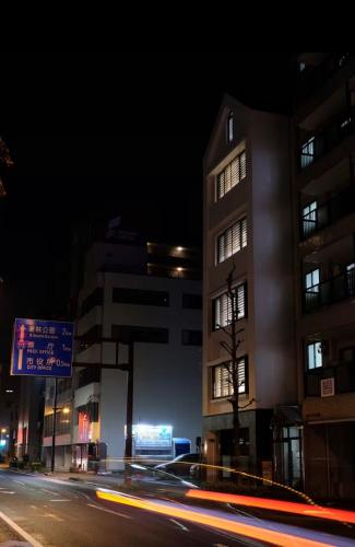 a building on a city street at night at Jasmin錦町2F 高松駅近 畳の癒し空間 in Takamatsu
