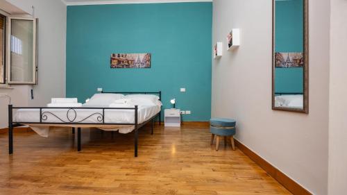 a bedroom with a bed and a blue wall at House Dafal by Rentbeat in Guidonia