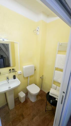 a bathroom with a sink and a toilet and a mirror at Residenze del Borgo in Zavattarello