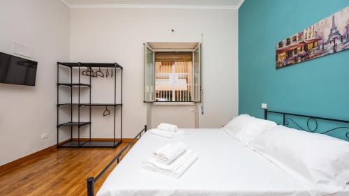 a bedroom with a white bed and a window at House Dafal by Rentbeat in Guidonia