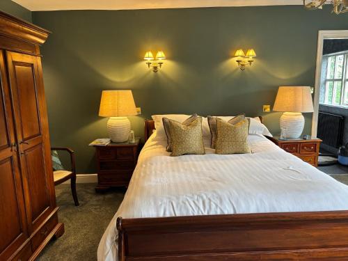 a bedroom with a bed with two lamps on it at The Crown Inn Roecliffe in Roecliffe