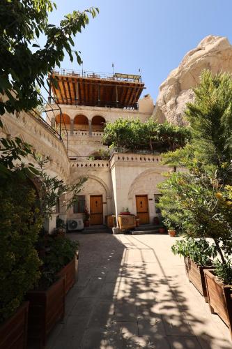 a building with a balcony on top of it at Roma Cave Suite in Goreme
