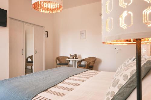 a bedroom with a bed and a table with chairs at Milano 71 in Milan