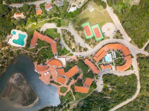 an aerial view of a house with a pool and a yard at Felix Hotels - Residence Hotel Costa Serena in Palau