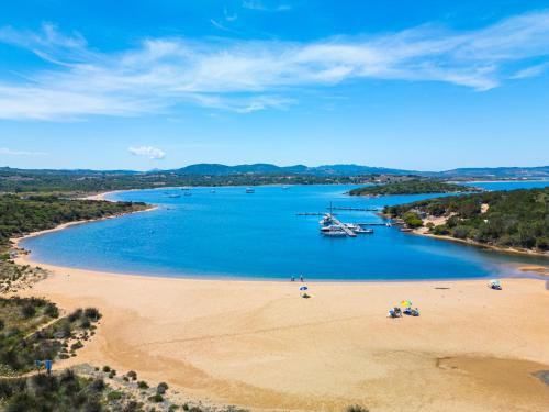 an aerial view of a beach with boats in the water at Felix Hotels - Residence Hotel Costa Serena in Palau