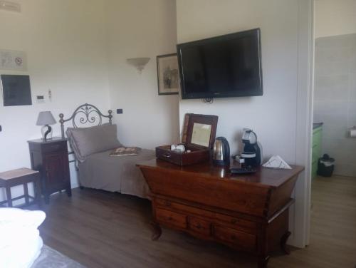 a living room with a couch and a flat screen tv at CASCINA LAI - Oasi Naturalistica - Camere private in Santena